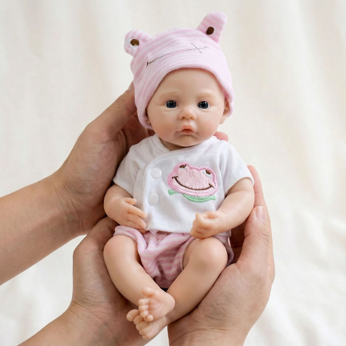 Muñeca reborn de silicona sólida de 12 pulgadas con gorro de rana rosa para regalo de Navidad infantil
