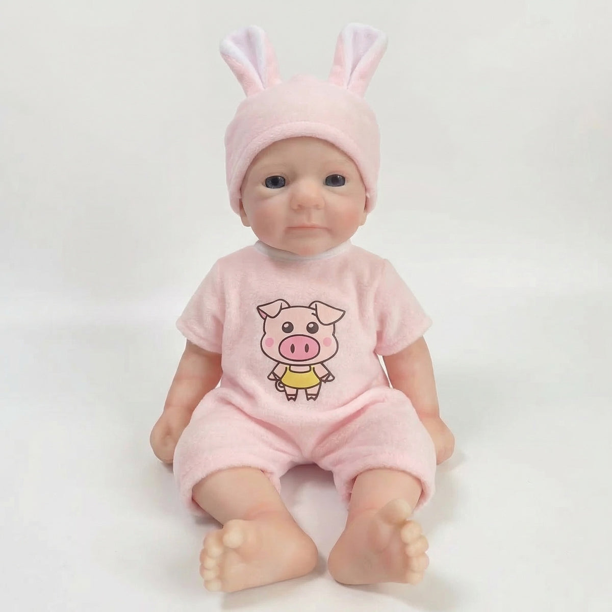 Muñeca de simulación de 12 pulgadas con gorro de orejas de conejo, muñeca de silicona de reencarnación