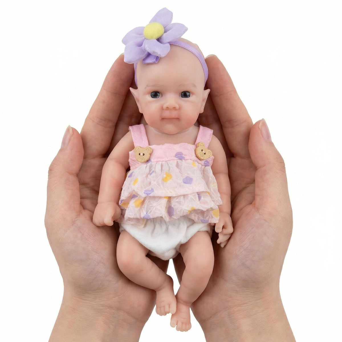 Muñeca de renacimiento de silicona pura con flor en la cabeza de 8 pulgadas, color morado