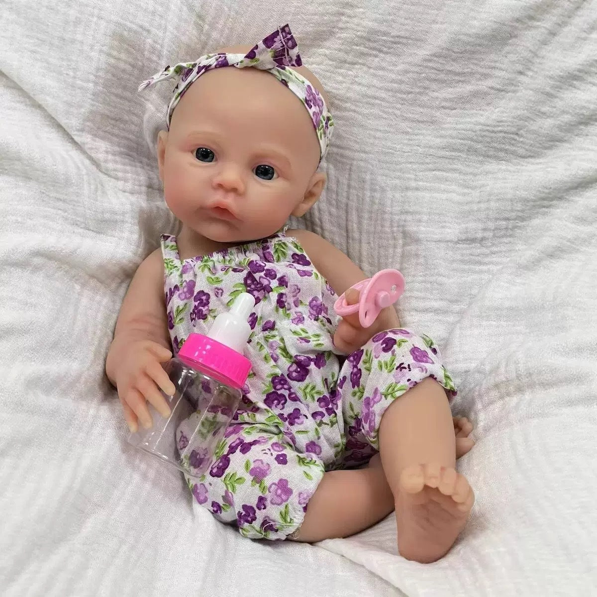 Muñeca reborn de silicona sólida de 12 pulgadas con diseño de flores prensadas en el prado