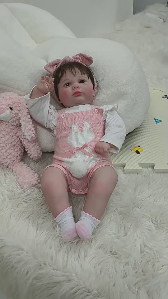 Muñeca bebé de vinilo realista de 26 pulgadas/65 cm con conjunto rosa y diadema con lazo – Muñeca coleccionable pintada a mano con ojos marrones